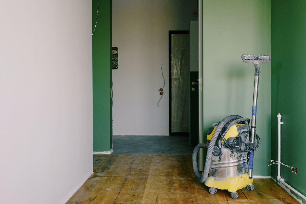 A shop vacuum standing in a freshly renovated corridor